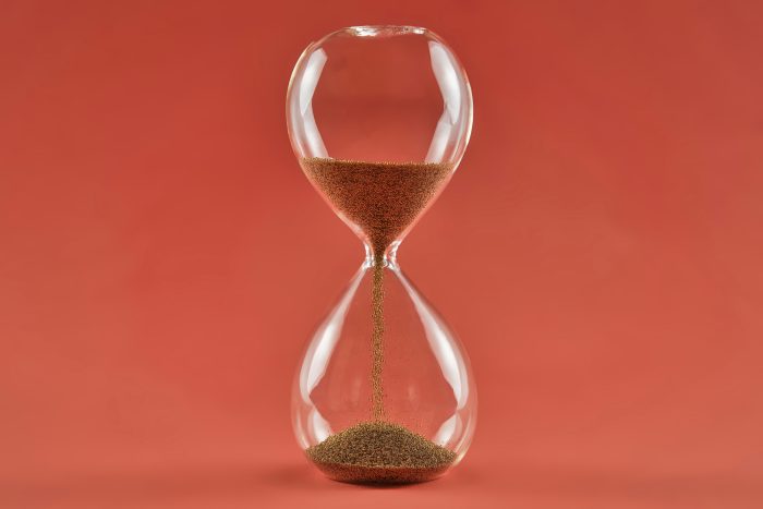 Sand runs through an hourglass